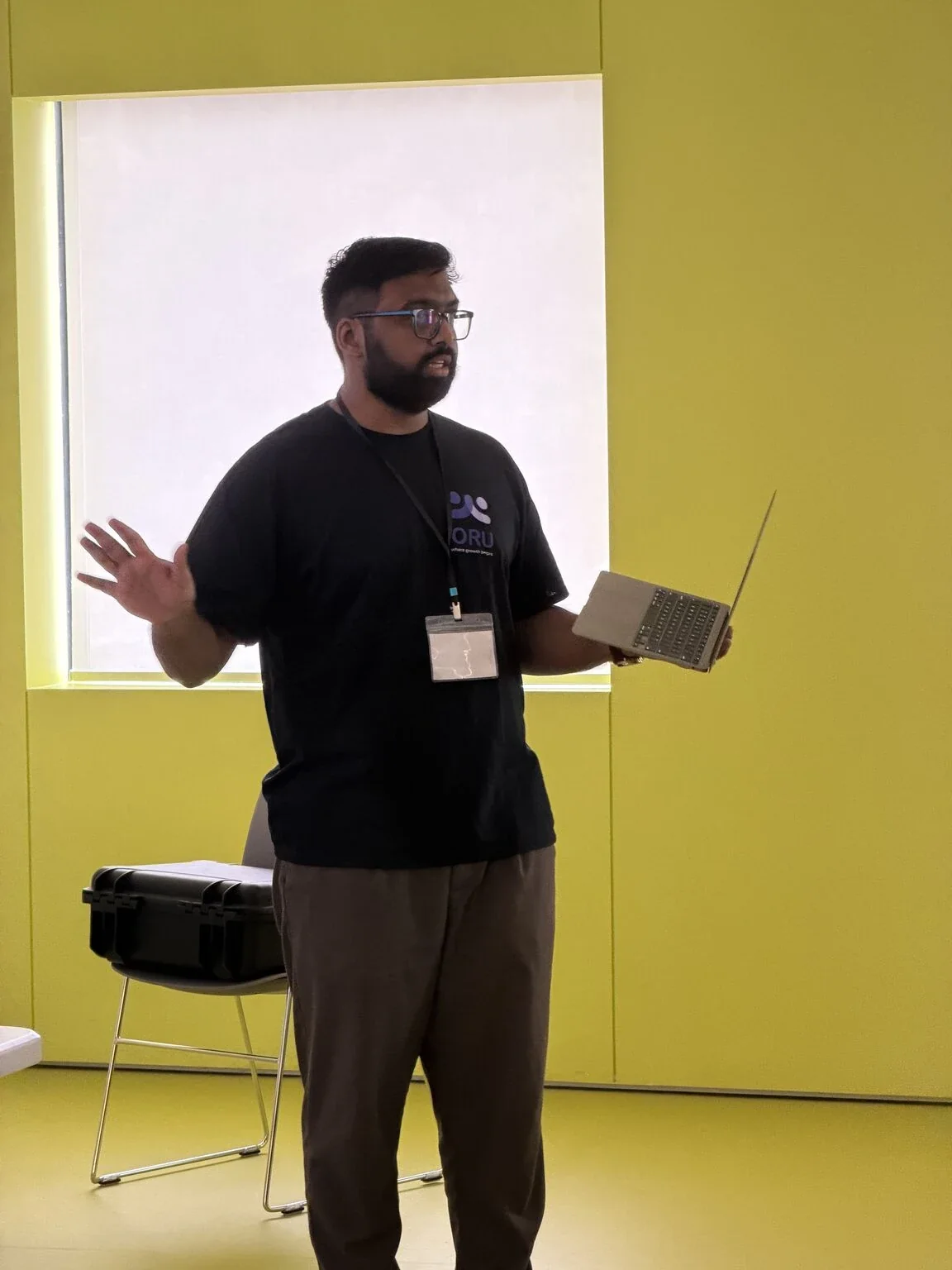 Adnaan running a workshop, laptop in hand